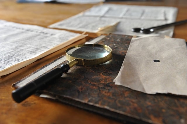 Documents and a magnifying glass on a desk of an Uber accident lawyer.