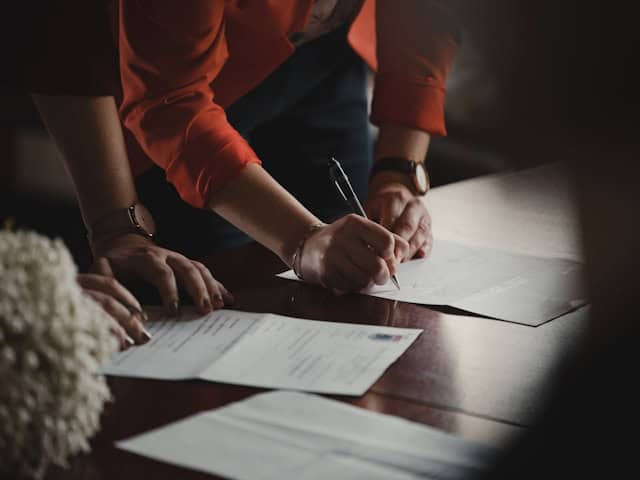Two people review a contract.