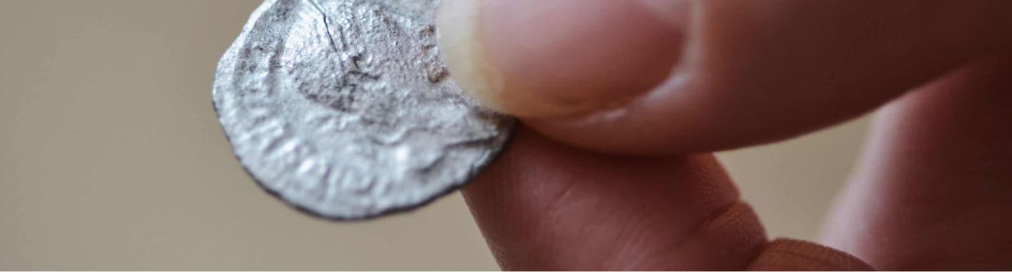 a person holding a coin