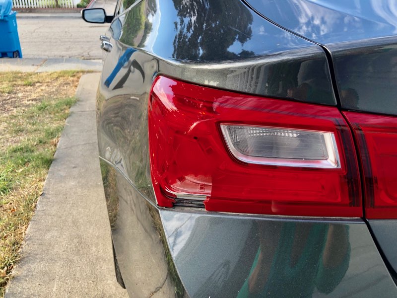 The car involved in the rear-end collision suffered serious damage.