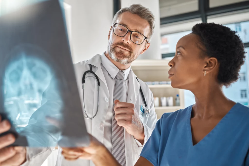 Doctor looks at medical tests to determine what type of head injuries the patient suffered.