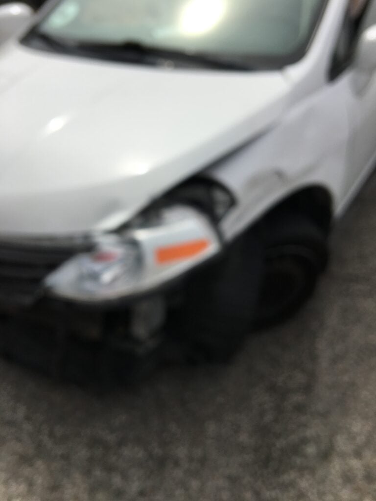 Car with front end damage due to traffic accident.