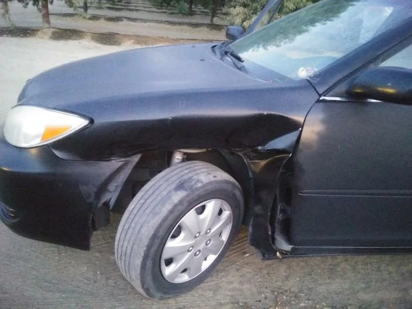 Damage to the left front of the victim's car caused by the impact after the U turn.