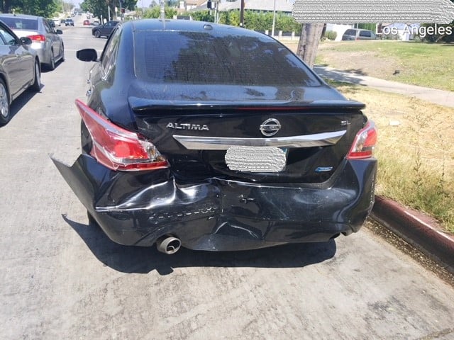 The rear end of the plaintiff's car was destroyed after the accident.