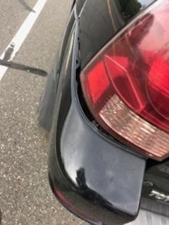 The rear bumper was detached from the car upon impact.