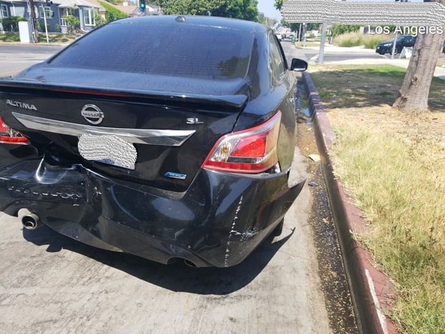 Bumper hanging from the accident victim's car.
