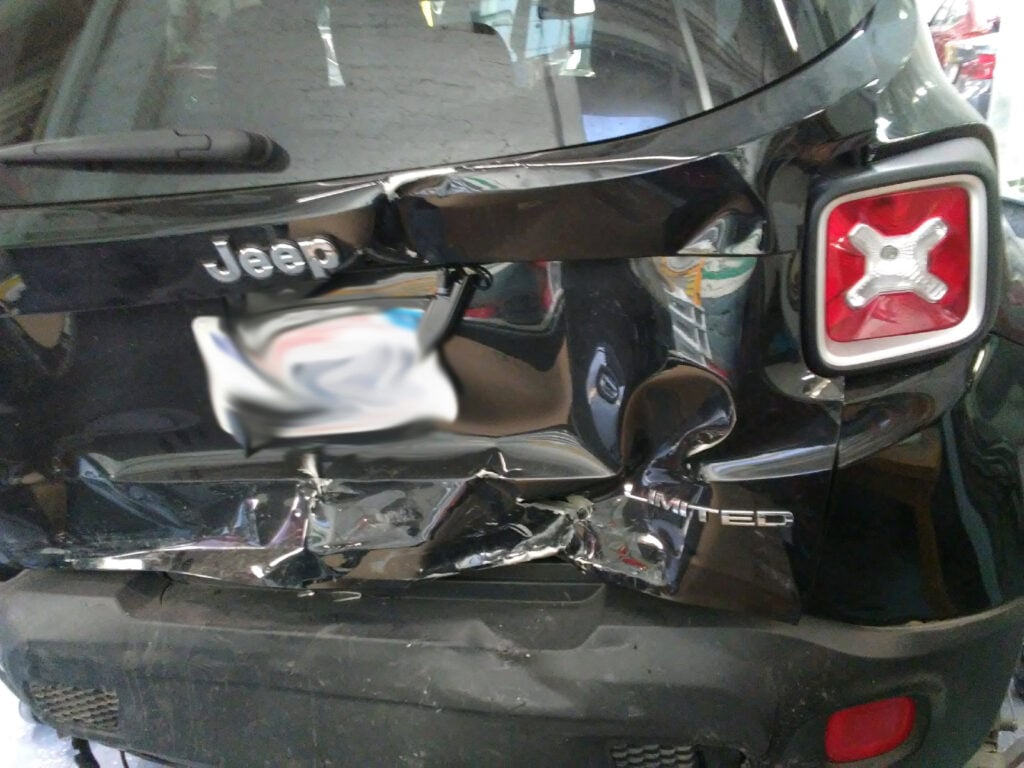 The trunk of the car hit from behind completely damaged.