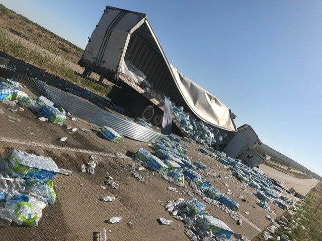 The defendant's truck load was thrown across the Amarillo roadway after the accident.