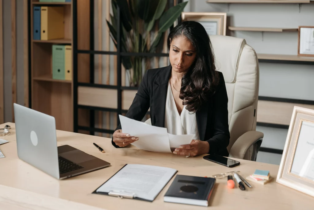 a female lawyer examining papers on her desk