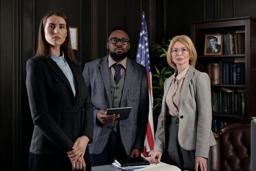 Three lawyers standing in a room