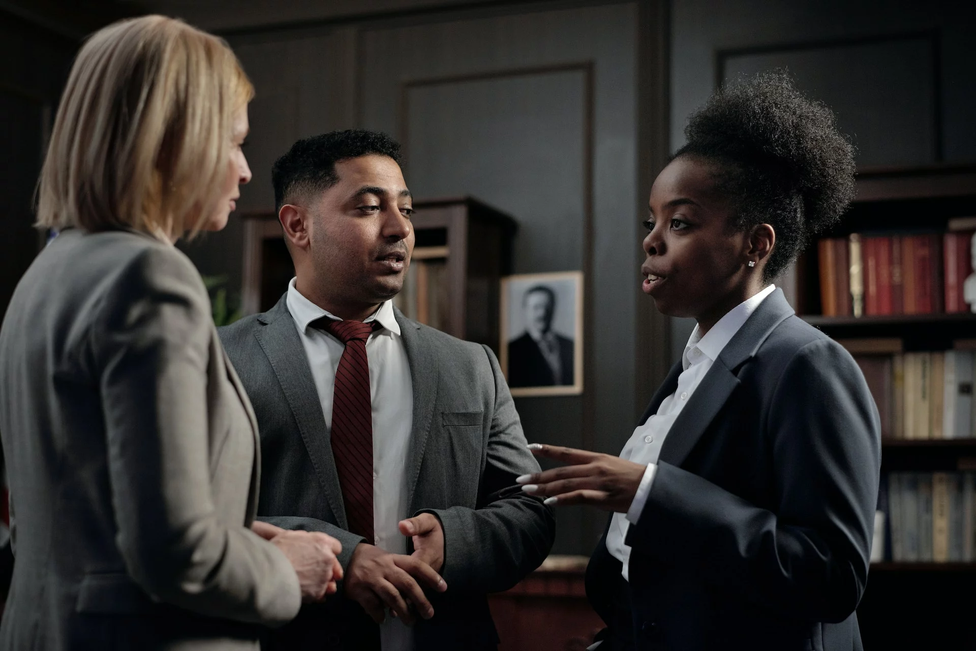 Three people talking inside a room