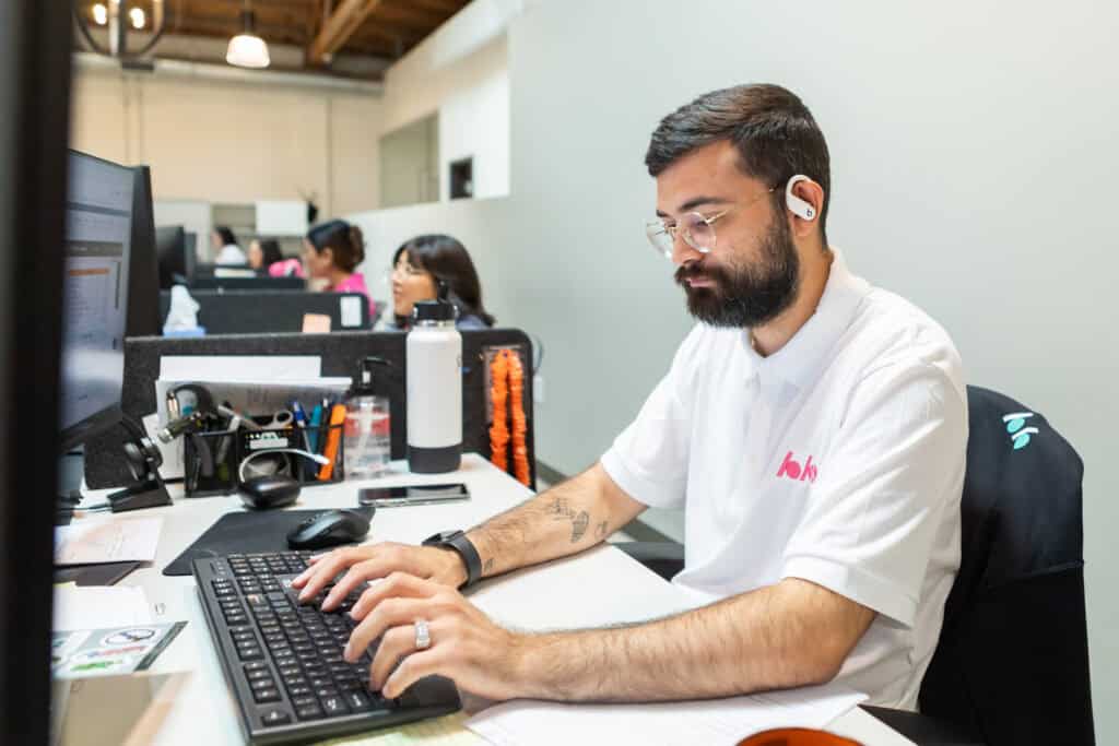 adamson ahdoot employee typing on his keyboard