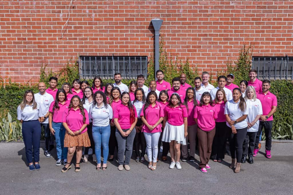 picture of adamson ahdoot employees dressed in their pink and white polos