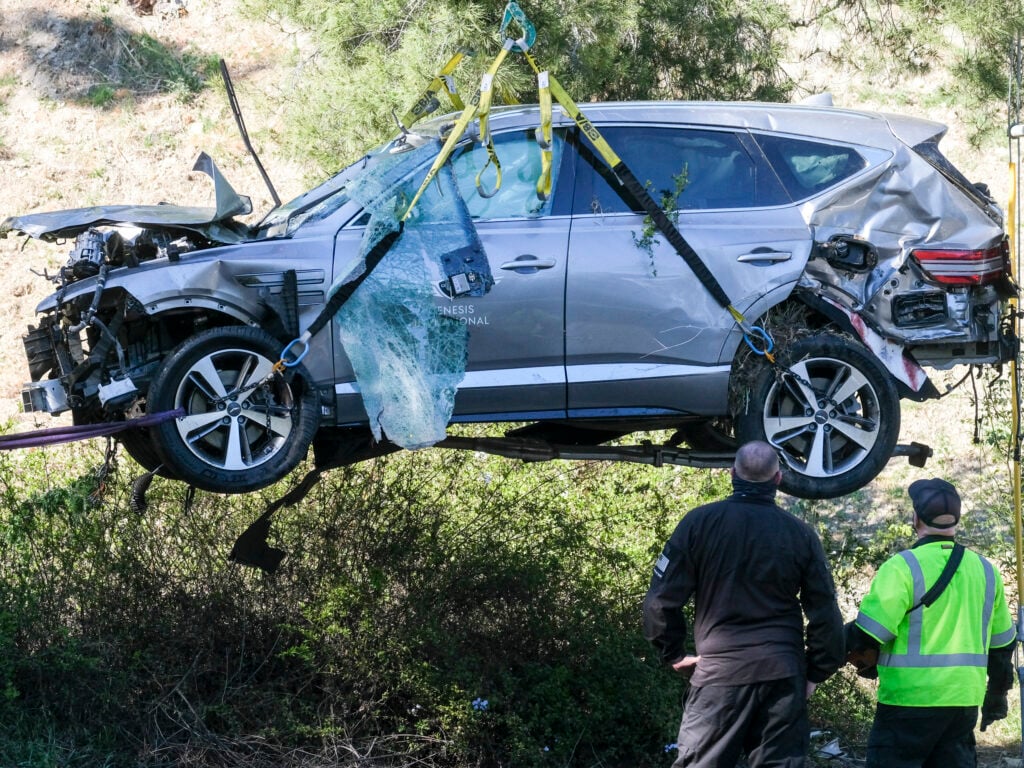 Woods suffered a brutal car crash resulting in a broken leg.