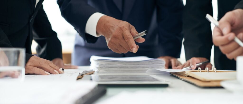 Attorney points to the documents that show proof for a civil litigation case.