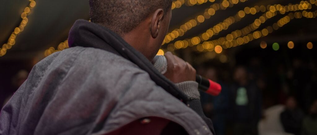 Hip hop singer raps at a concert against sexual assault and trafficking.