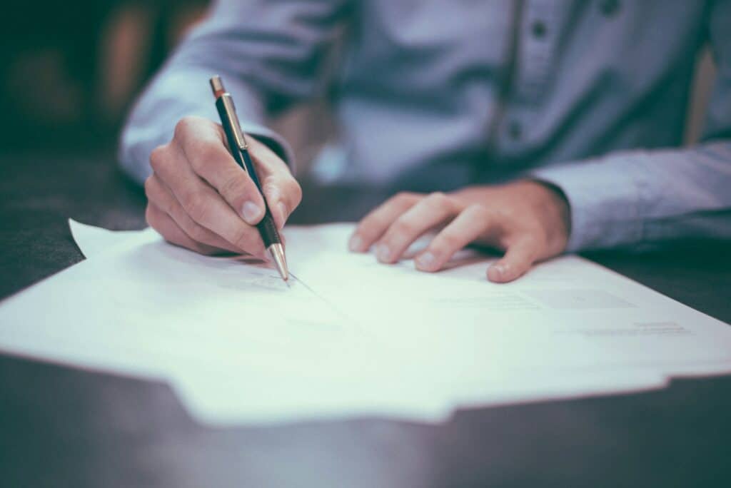 Financial abuse lawyer signs documents.
