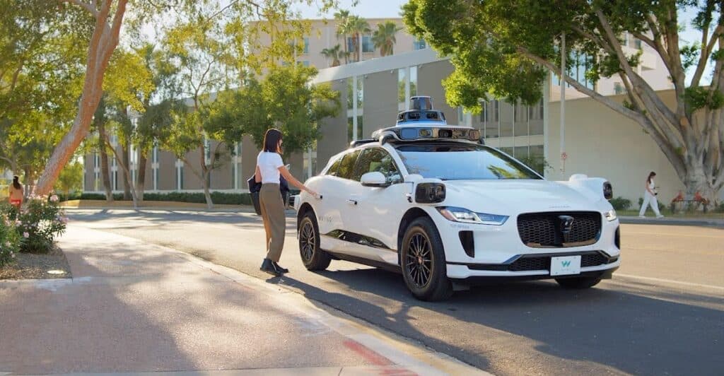 One of Waymo's autonomous taxis picking up a passenger.