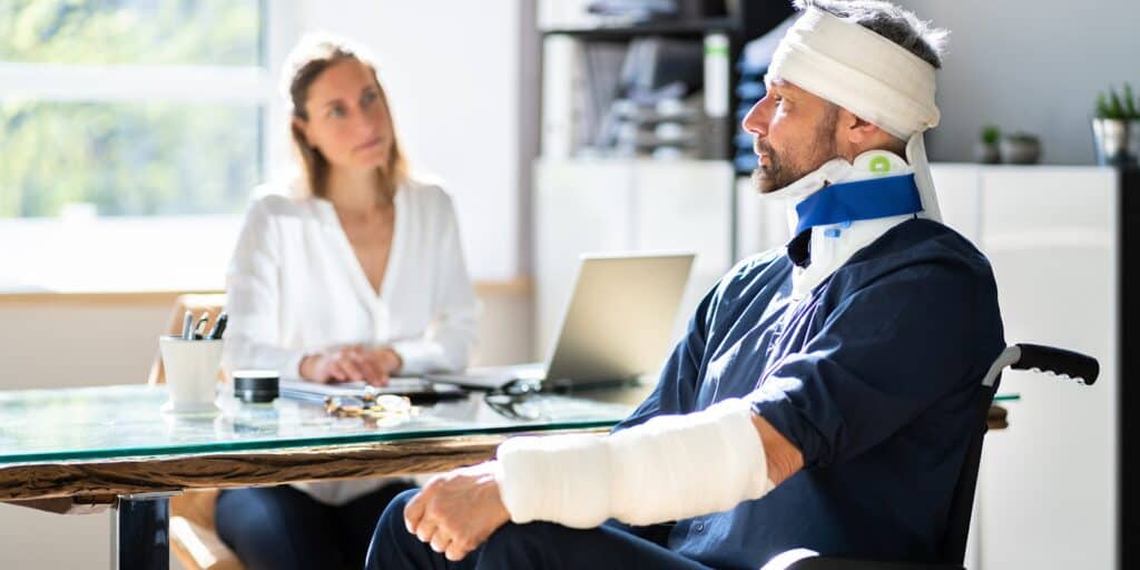 A person with catastrophic injuries talking to a doctor.