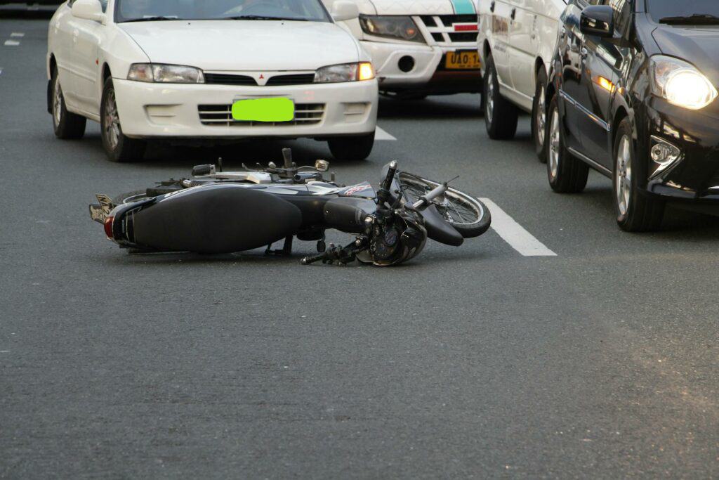 Damaged motorcycle and debris on the road after an accident