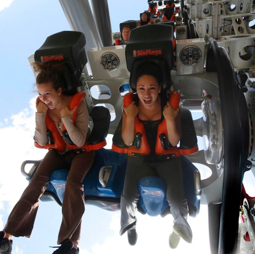 Dos mujeres se montan en la atracción X2 de Six Flags Magic Mountain.