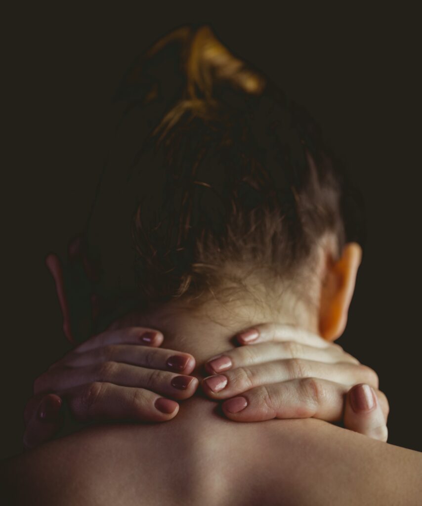 Mujer con dolor de cuello se toca las cervicales.