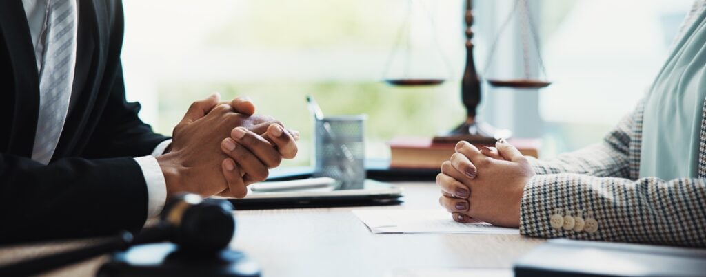 Lawyer and client in a meeting for a legal consultation about a negligence case.