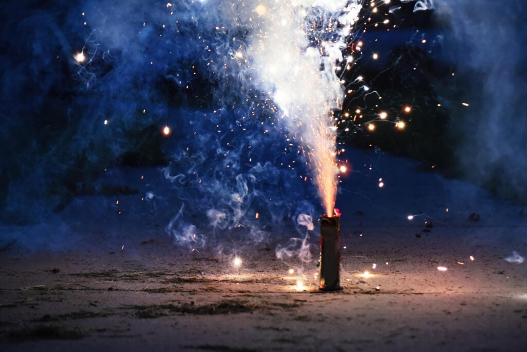 Fireworks set off during a Fourth of July celebration causing smoke and potential injury risks