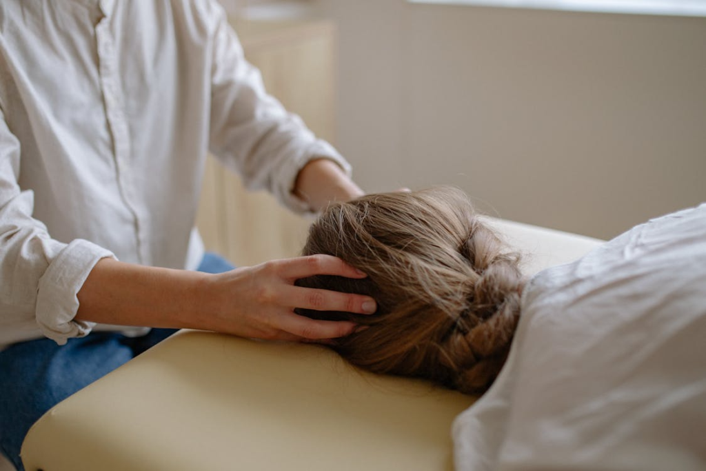 Healthcare professional providing therapeutic care to a patient during brain injury rehabilitation